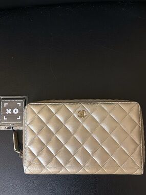 CHANEL Quilted Zip Wallet in Metallic Gold